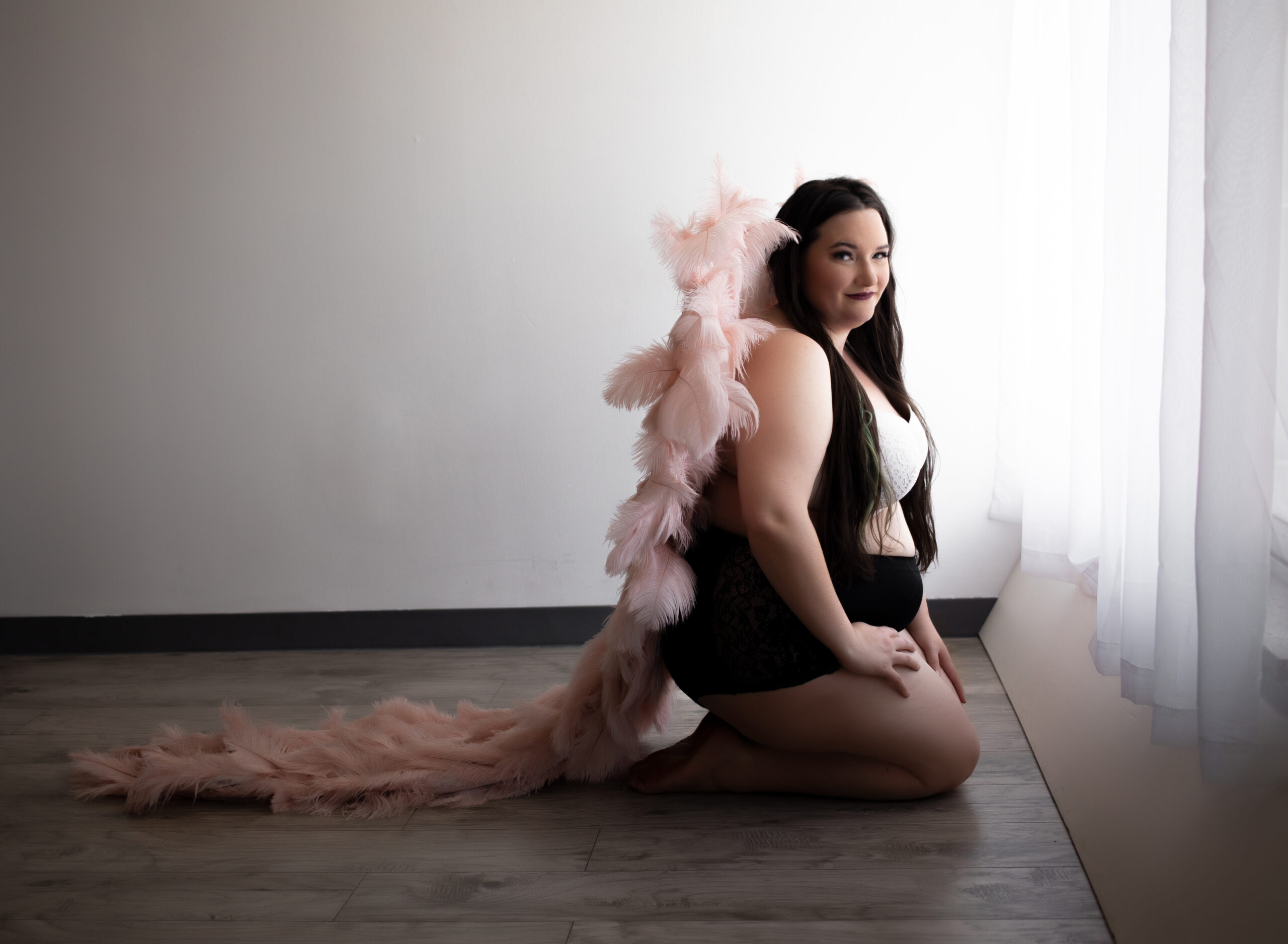 Women in angel wings, posing during her empowerment session